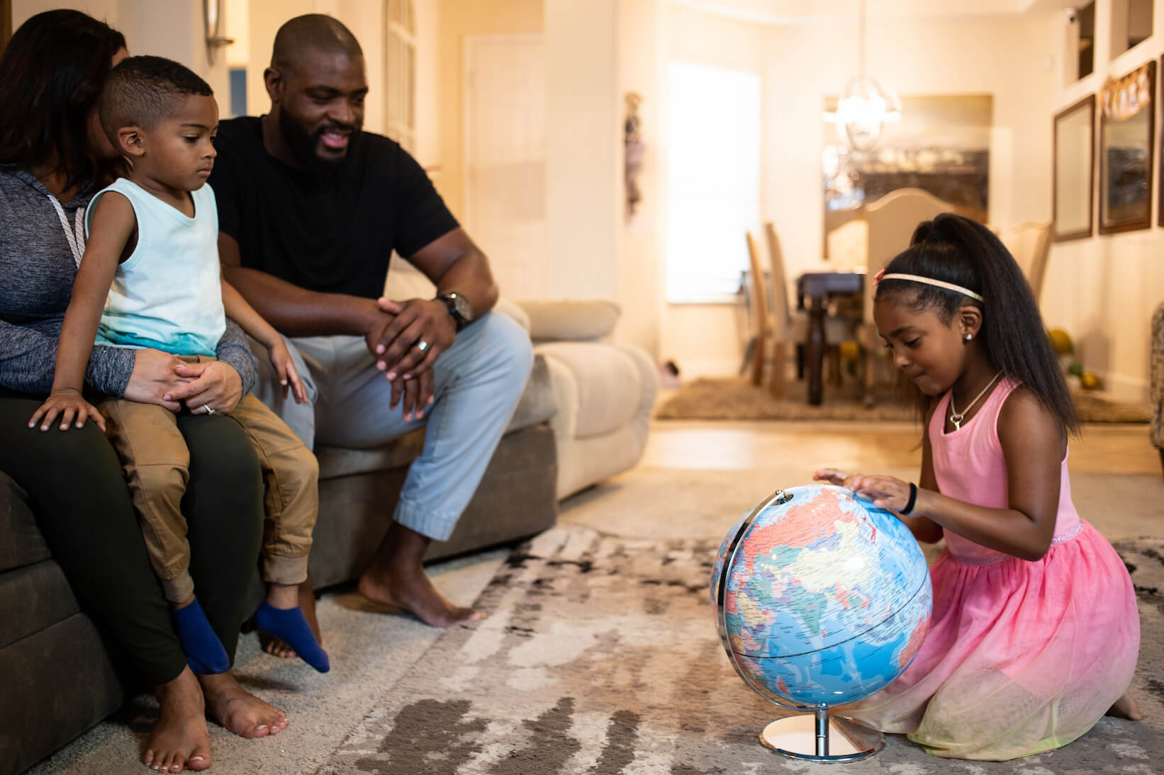 Homeschoolers look at a globe; a classical math curriculum is interdisciplinary.