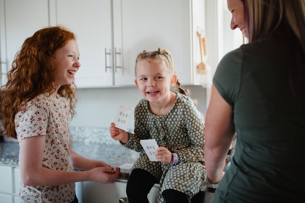 Homeschoolers practice math with multiplication flash cards.