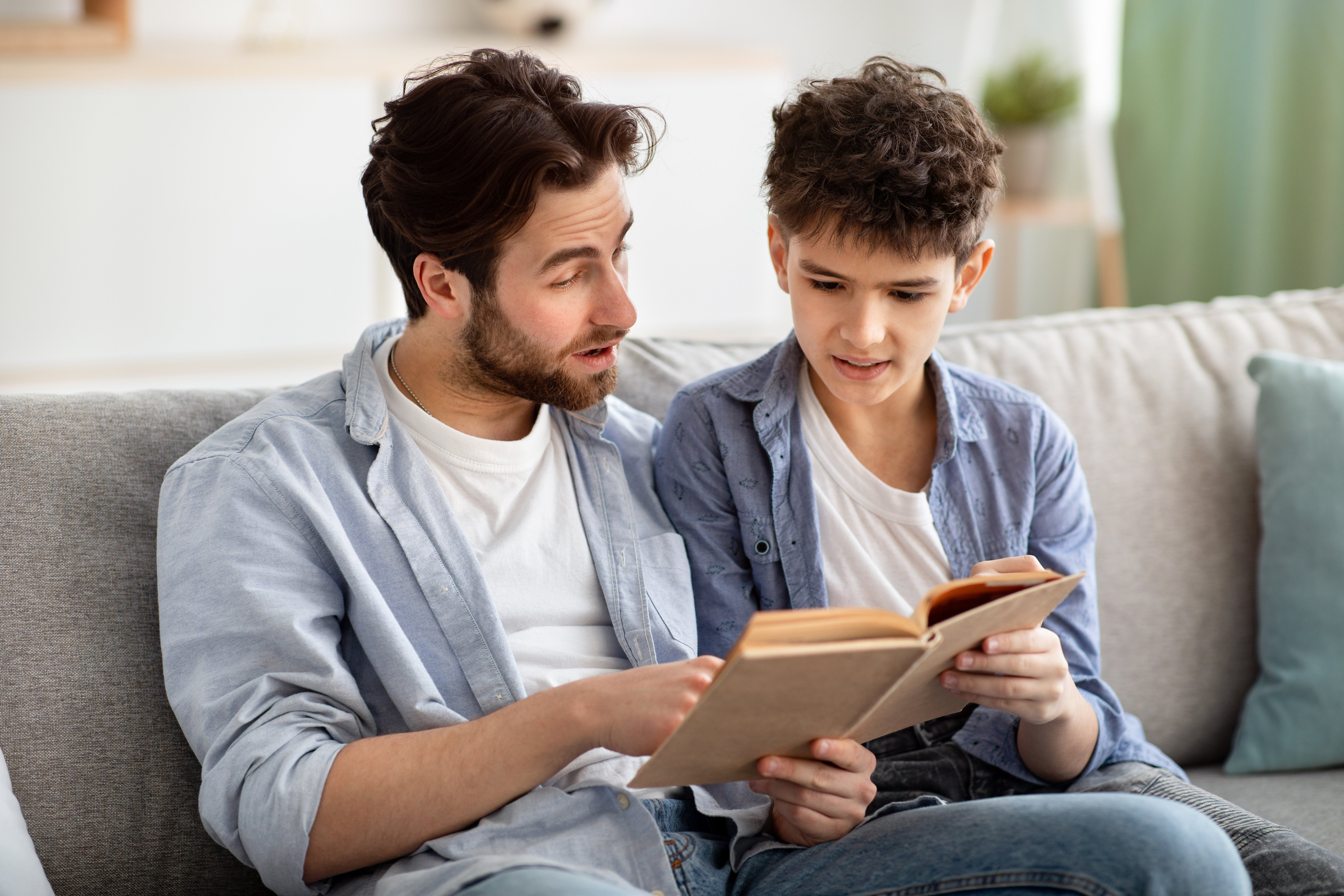 family-pastime-father-and-teen-boy-reading-book-t-2021-09-02-05-01-49-utc